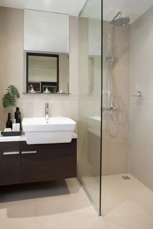 black wooden vanity with white counter top and sink placed on the brown floor