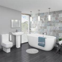 Restful white bathroom is equipped with facing white washstands fitted with Kohler faucets fixed under beveled vanity mirrors lit by nickel sconces and a