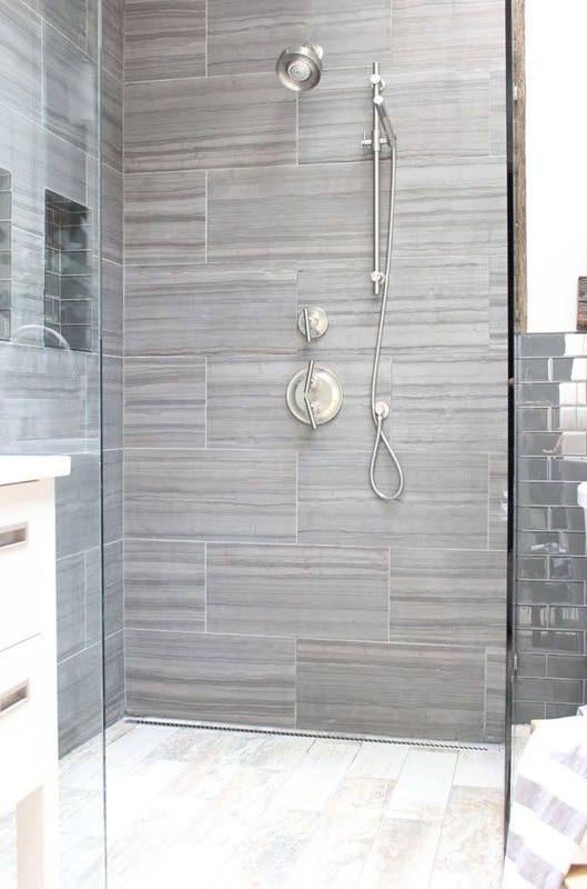 Traditional master bathroom with wall sconces, a corner shower and undermount sinks