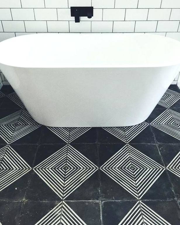 Julie from Milton Keynes uses a walnut finished basin unit and dark tiles to create a stylish bathroom in a small space