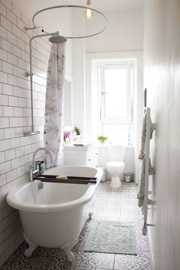 Narrow bathroom benefits from shower window to break up the space and provide fresh air