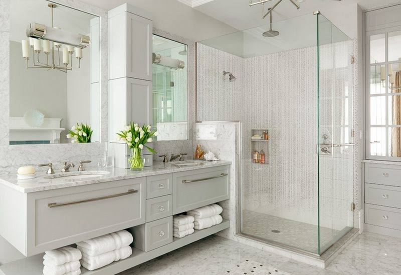 This shot showcases the kitchen's modish bathroom featuring marble vessel sinks