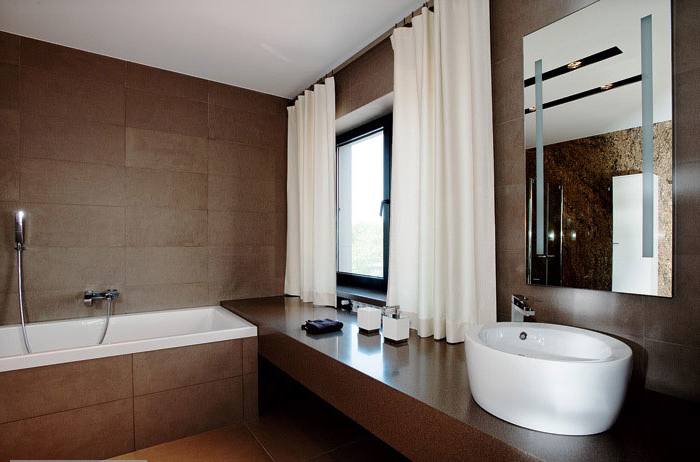 The brown wood flooring design captures this pure white bathroom scheme