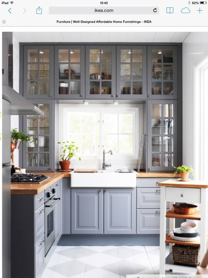 Small black and white kitchen with chalk doors inscribed with messages