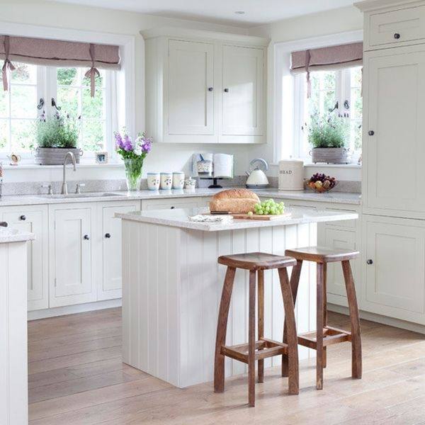 cream wooden cabinet and kitchen island with brown counter top completed with white wooden