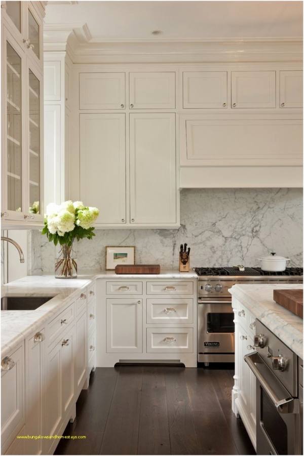 Gray tiles shape a lovely background in the small kitchen [Design: CliqStudios Cabinets]