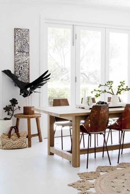 Transitional blue dining room with rectangular table and white highback chair