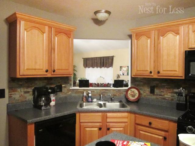 Dark floors,white cabinets, white granite, silver knobs and gray paint  wall