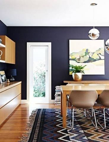 Upholstered chairs surround a circular table in this cheery dining room featuring light neutral tones and a stylish transitional theme