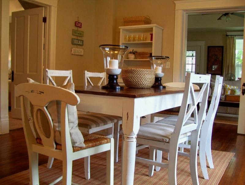 The incredible dark wood table in this dining room matches nicely with the  brick