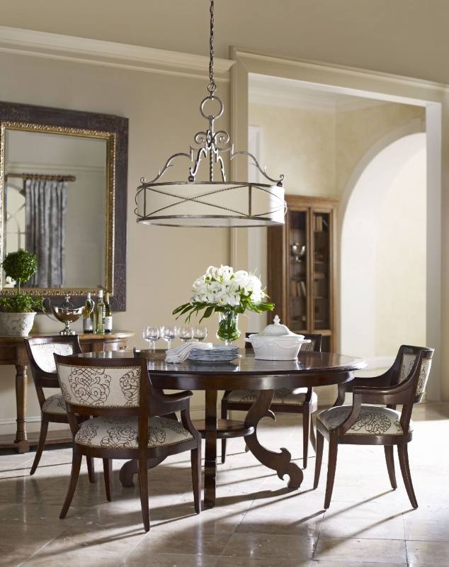 These rustic chairs and hanging chandelier look amazing with all of the  natural light in this classic dining room