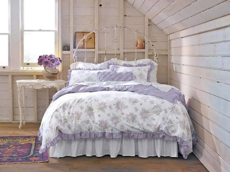 Wire pendant lights, bright accent pillows and colorful bedding shape  the shabby chic bedroom [