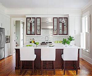 A Nathan Grey painting carries the dark motif of the kitchen into the dining  space