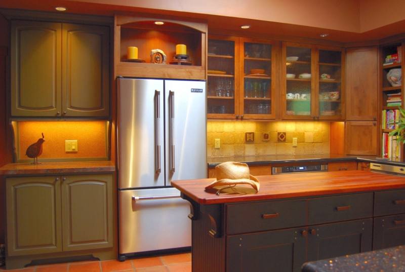 White oak kitchen cabinets with gloss white accents by Kitchen Craft  Cabinetry